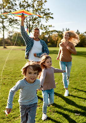 There are no words to describe how special kids are. Happy family playing a kite. Outdoor family weekend